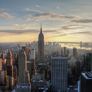 A painting of pastel colors - New York from the Rock at Sunset