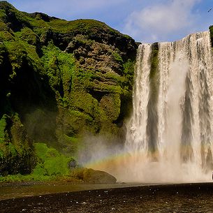 Girl staring at Skogafoss